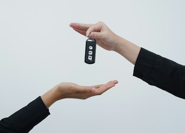 Car key being handed over to a customer