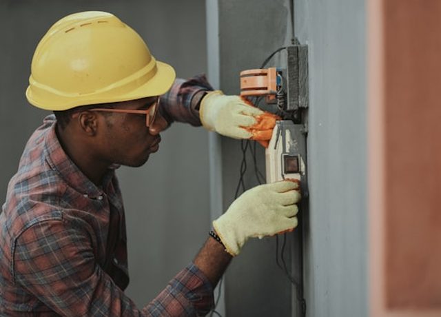 A technician working on equipment at a customer's property