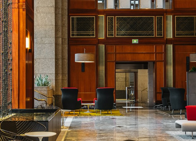 Hotel lobby lounge with seating and wood panelling