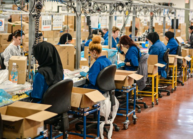 Workers at an assembly line in a factory