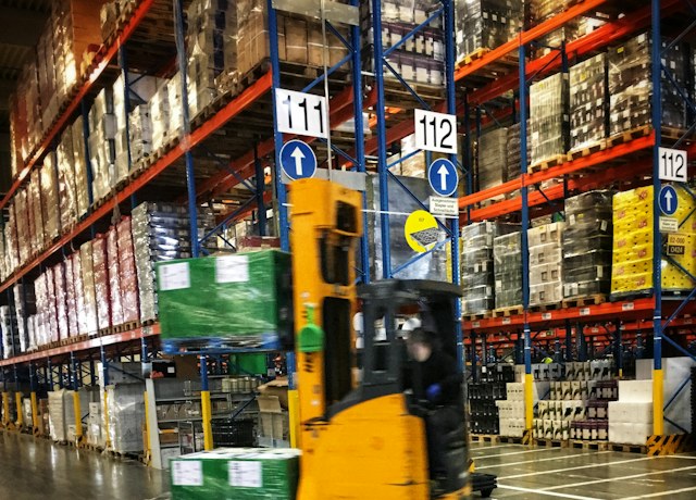 Forklift working in a warehouse aisle