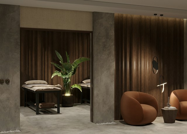 Calm spa treatment room with massage beds and plants